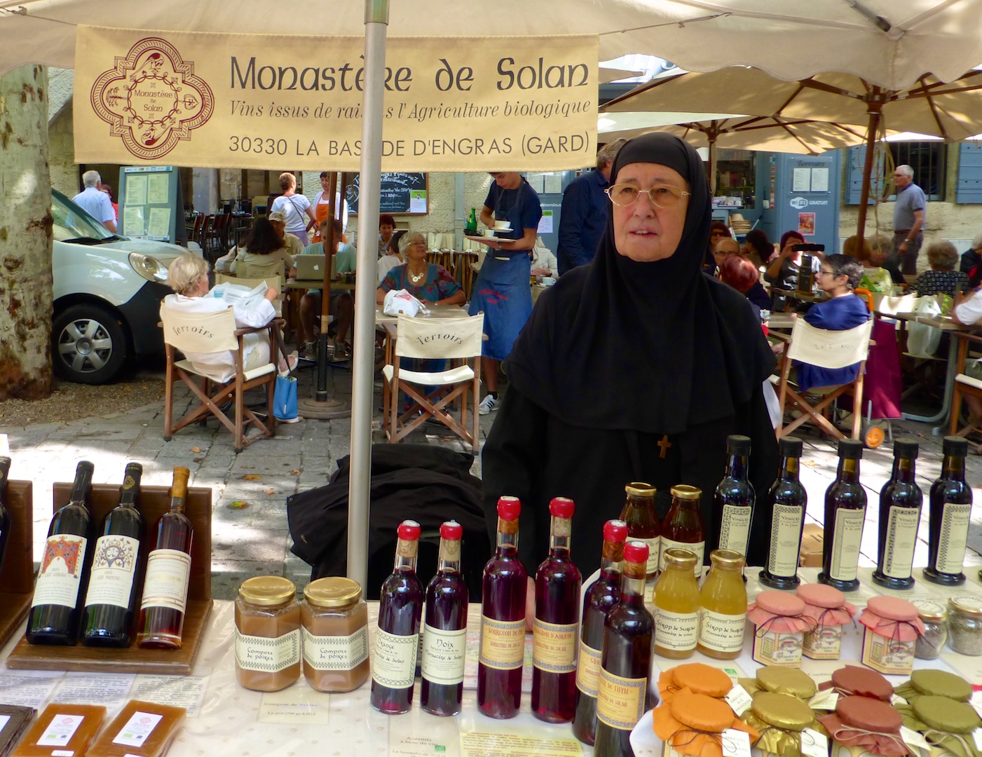 Nun selling wine at Wednesday Market in Uzes, Languedoc Roussillon, France