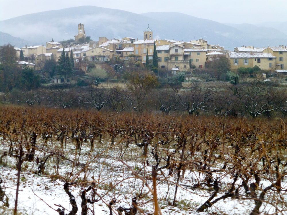 The view of Lourmarin, Provence, France in December snow 