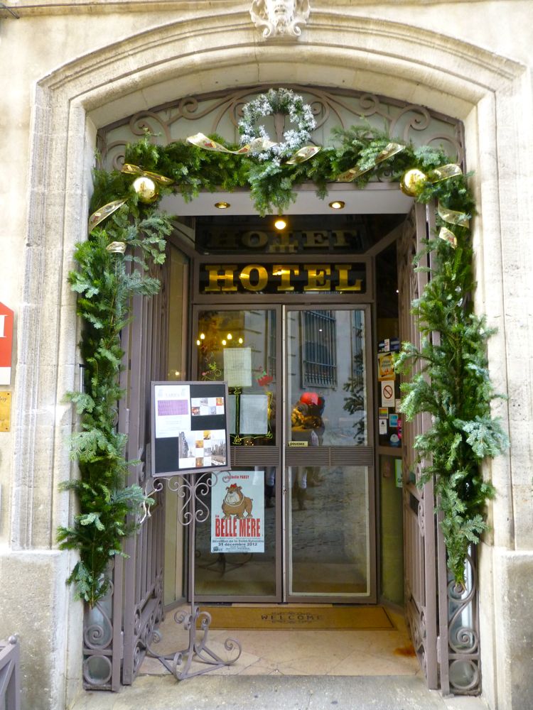 Restaurant doorway garlanded for Christmas in Avignon, Provence, France