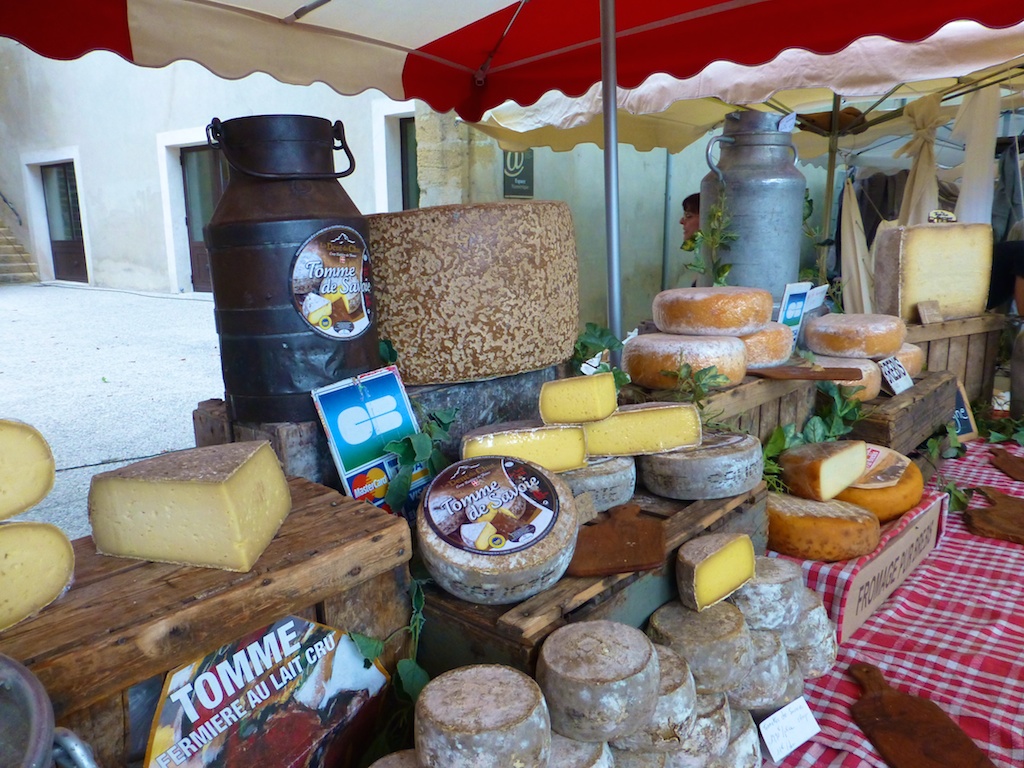 Cheeses for sale in the Lourmarin market, Luberon, Provence, France