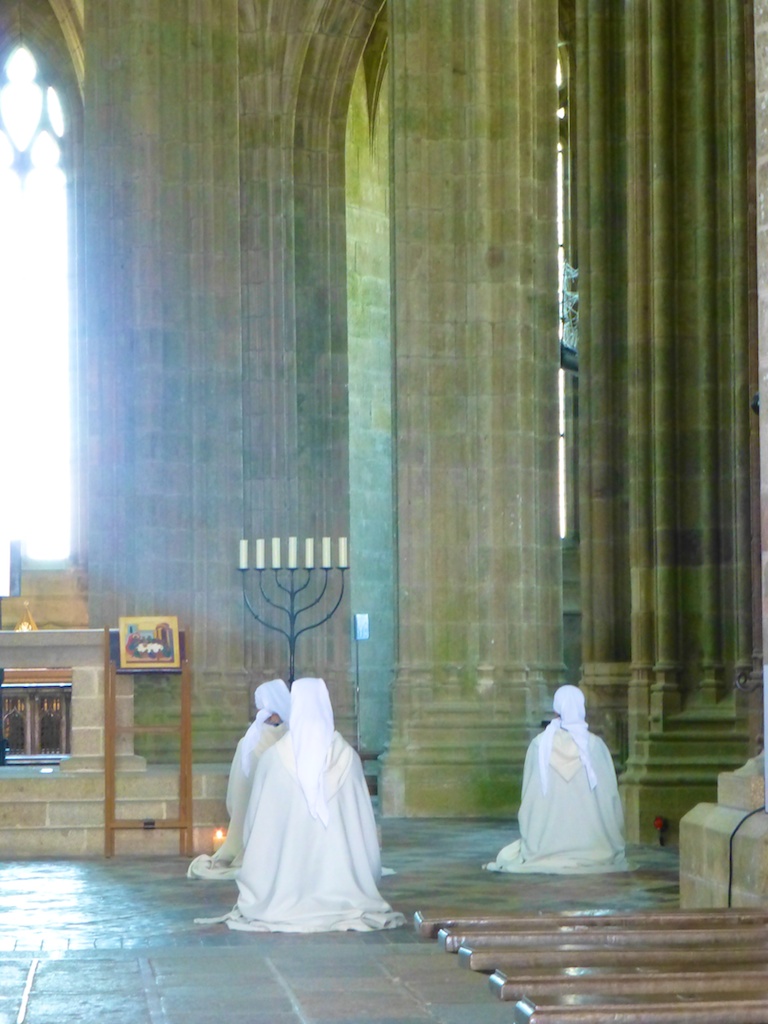 At prayer in the Abbey, Mont Saint Michel, France