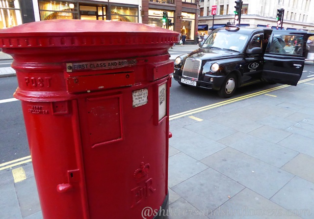 Red London letter boxes and black London taxis