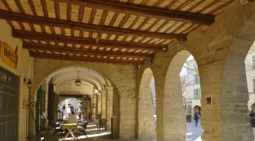 Arches of Place aux Herbes in Uzes