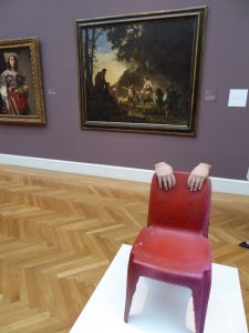 The hands on a chair sculpture inspired by Urs Fischer in the Legion of Honor San Francisco
