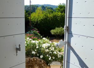 View through the shutters of a maison de village in Lourmarin, Provence, France