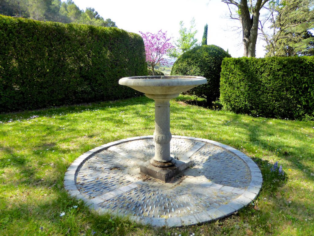 The label fountain at Le Château Constantin, Lourmarin, Luberon, Vaucluse, Provence, France