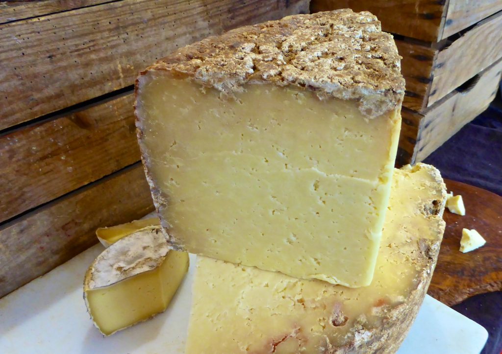 Cheese wedge in the Lourmarin market, Lourmarin, Luberon, Provence, France