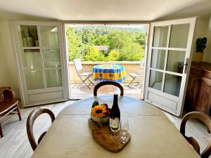 Dining area leading to terrace in our Lourmarin village house for rent